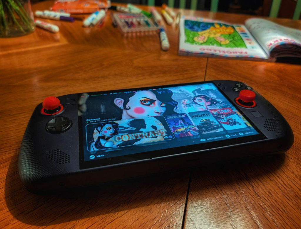 The Legion Go S with the game Contrast on an old table